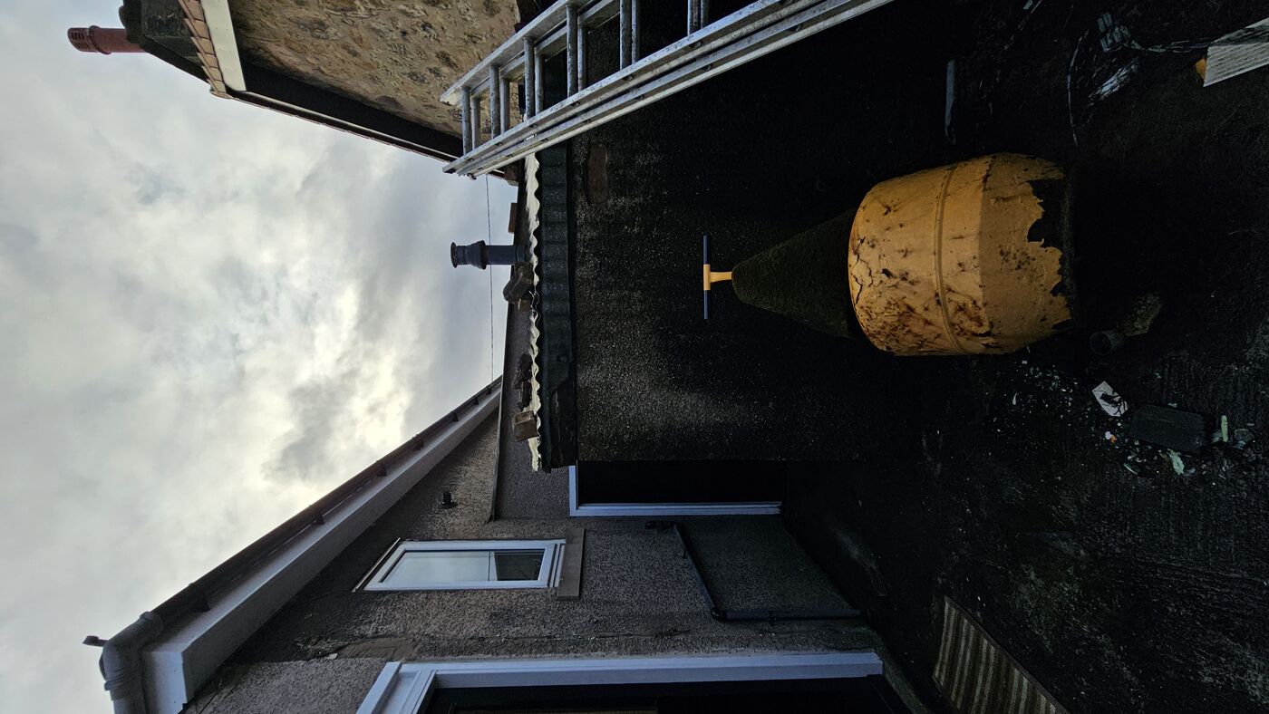 Rear courtyard — untreated render