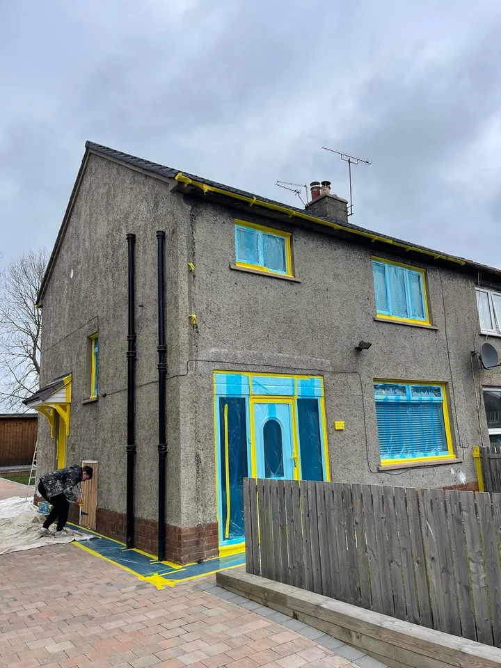 Windows and doors masked before spray application.